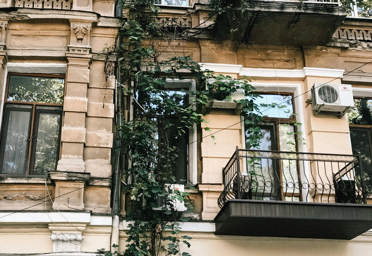 Photo of an apartment balcony with two heat pumps mounted on the exterior wall.